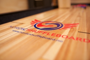 Nordic shuffleboard logo under playfield
